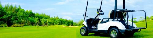 golf cart on green lawn with blue sky and cloud for background backdrop use